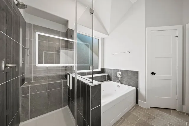a bathroom with a granite countertop sink a mirror and shower
