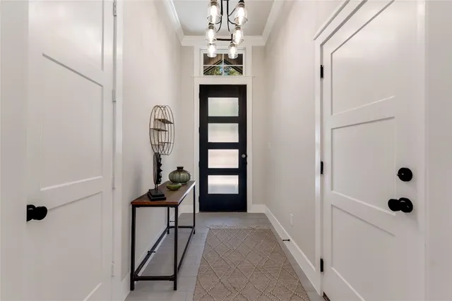 a view of a hallway to rooms and stairs