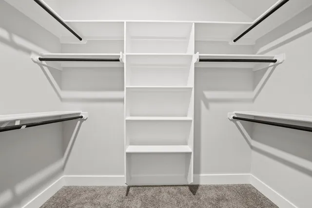 a view of walk in closet with empty racks