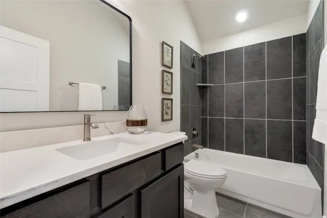 a bathroom with a sink a toilet a mirror and shower