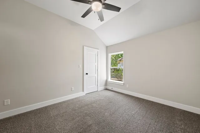 an empty room with a empty space and a ceiling fan