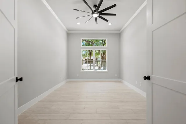 a view of a livingroom with a ceiling fan and window