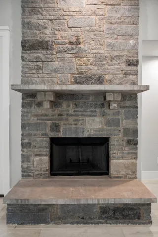 a fireplace with a clock on wall