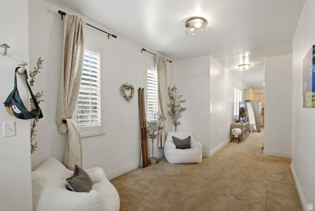 7772 South Rustic Cove Midvale, UT 84047 - Photo 4 of 39 Bright hallway featuring neutral walls, recessed ceiling lighting, and warm wood-finish flooring throughout