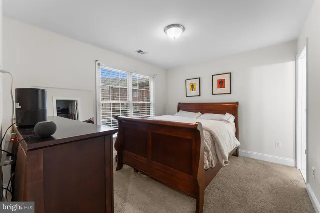 a living room with furniture gym equipment and windows