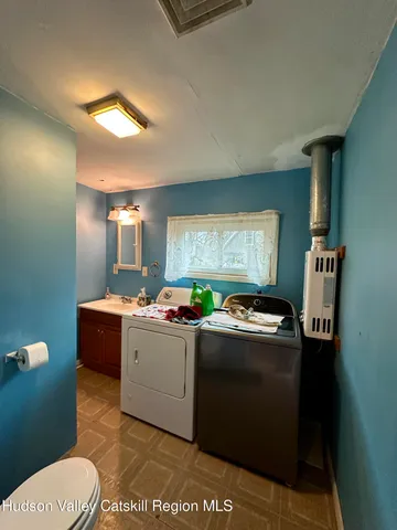 a kitchen with granite countertop a refrigerator a stove a sink and dishwasher