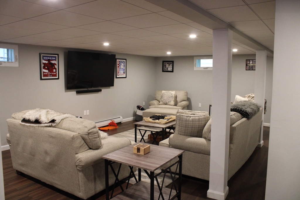 225 Braemoor Road Brockton, MA 02301 - Photo 25 of 29 a living room with furniture and a flat screen tv