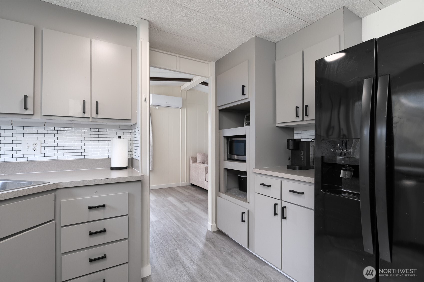 4540 Monkey Hill Road Oak Harbor, WA 98277 - Photo 11 of 36 a kitchen with white cabinets and refrigerator