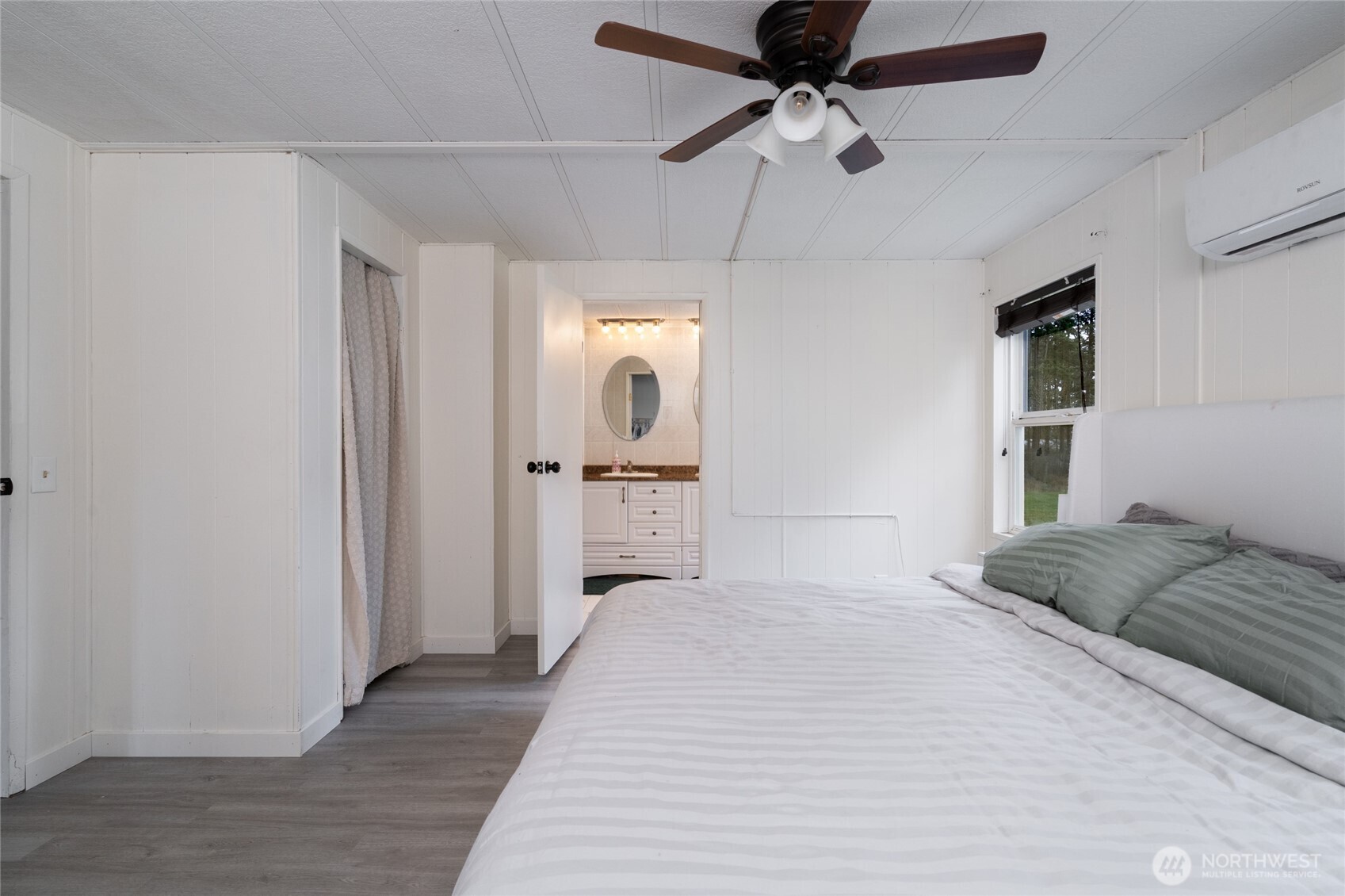 4540 Monkey Hill Road Oak Harbor, WA 98277 - Photo 15 of 36 a bedroom with a bed and a chandelier