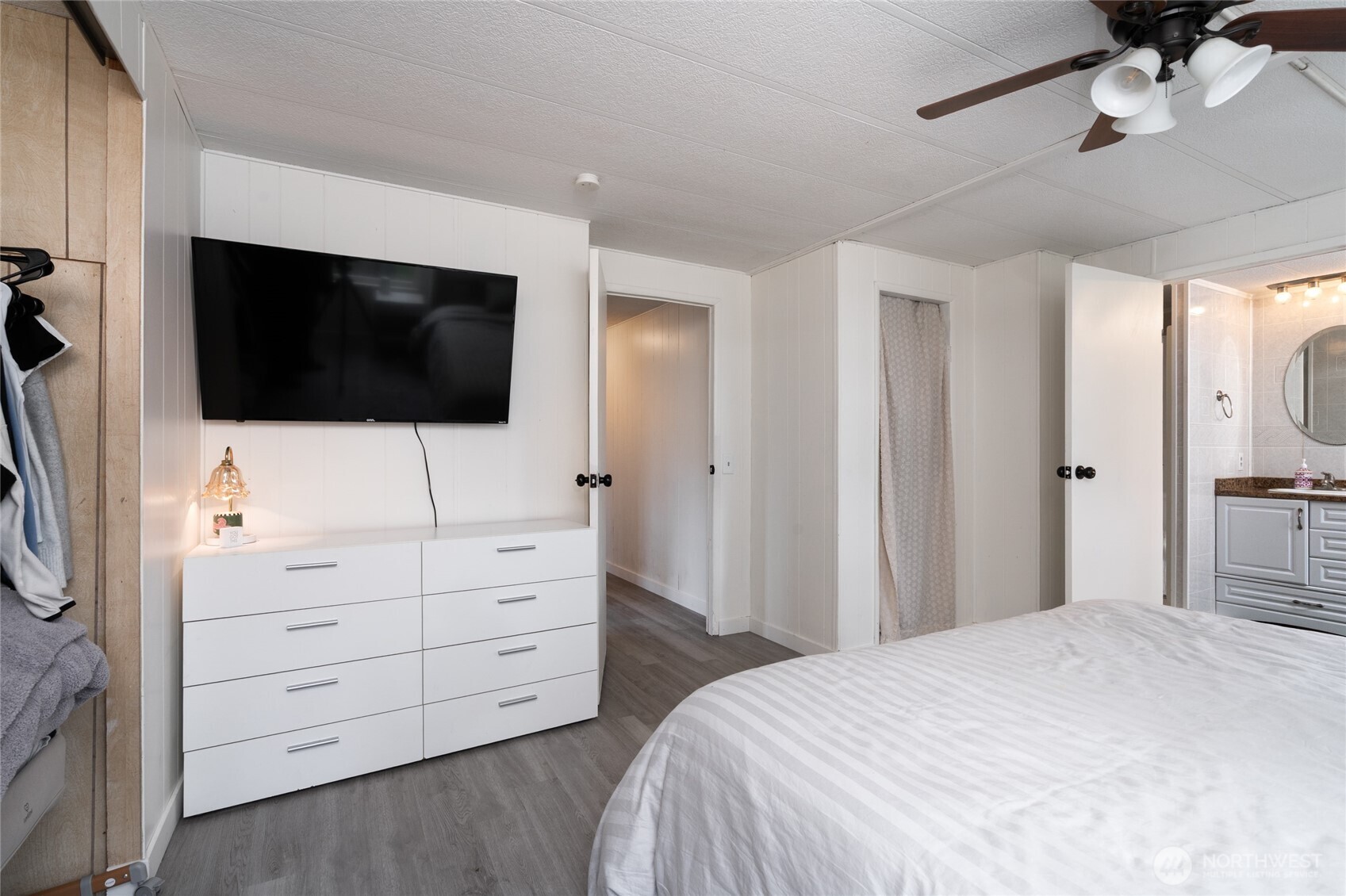 4540 Monkey Hill Road Oak Harbor, WA 98277 - Photo 16 of 36 a bedroom with a bed and a flat tv screen in a dresser