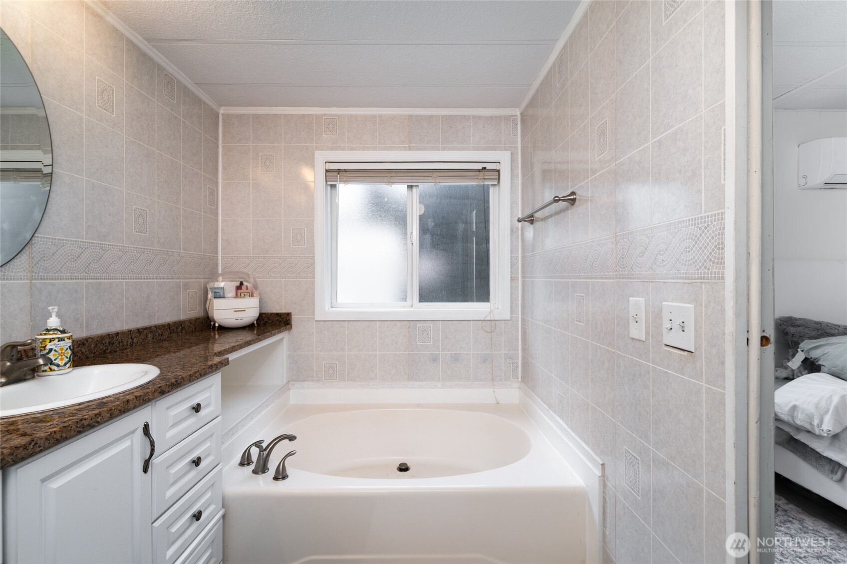 4540 Monkey Hill Road Oak Harbor, WA 98277 - Photo 18 of 36 a bathroom with a granite countertop tub sink and mirror