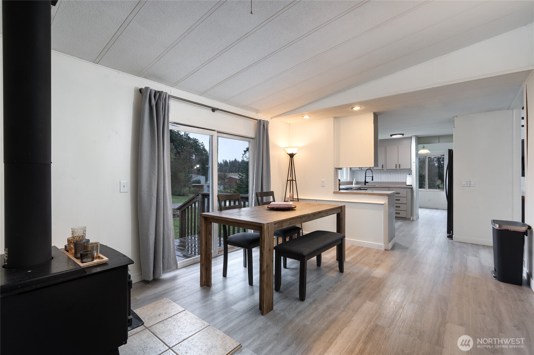 4540 Monkey Hill Road Oak Harbor, WA 98277 - Photo 6 of 36 a dining room with a table chairs and kitchen view