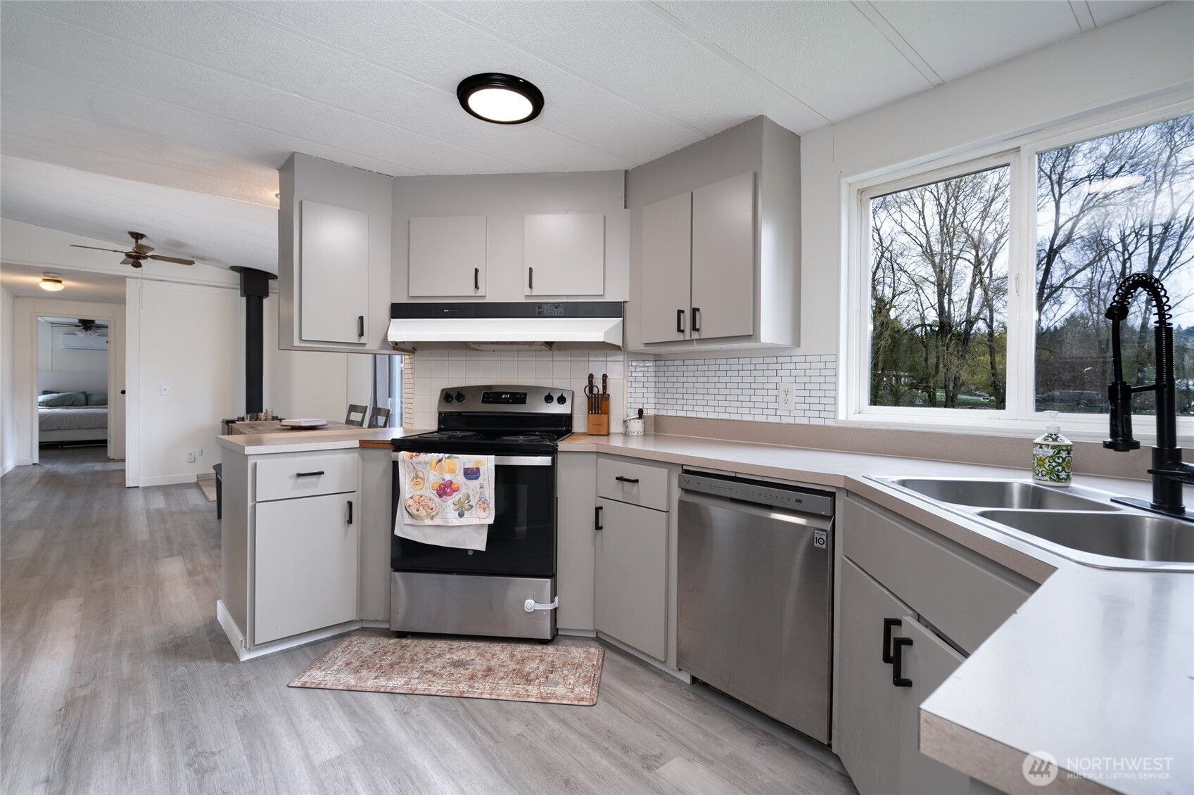 4540 Monkey Hill Road Oak Harbor, WA 98277 - Photo 9 of 36 a kitchen with a refrigerator stove and sink