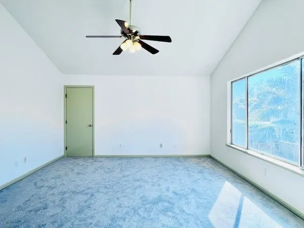 a view of room with window and ceiling fan