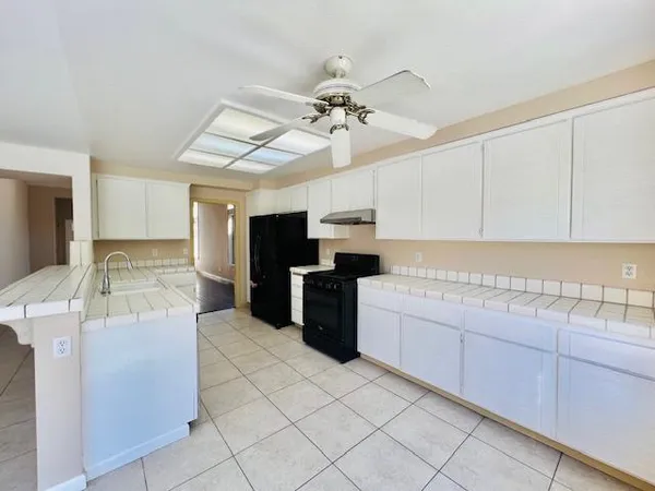 a kitchen with a stove top oven and cabinets