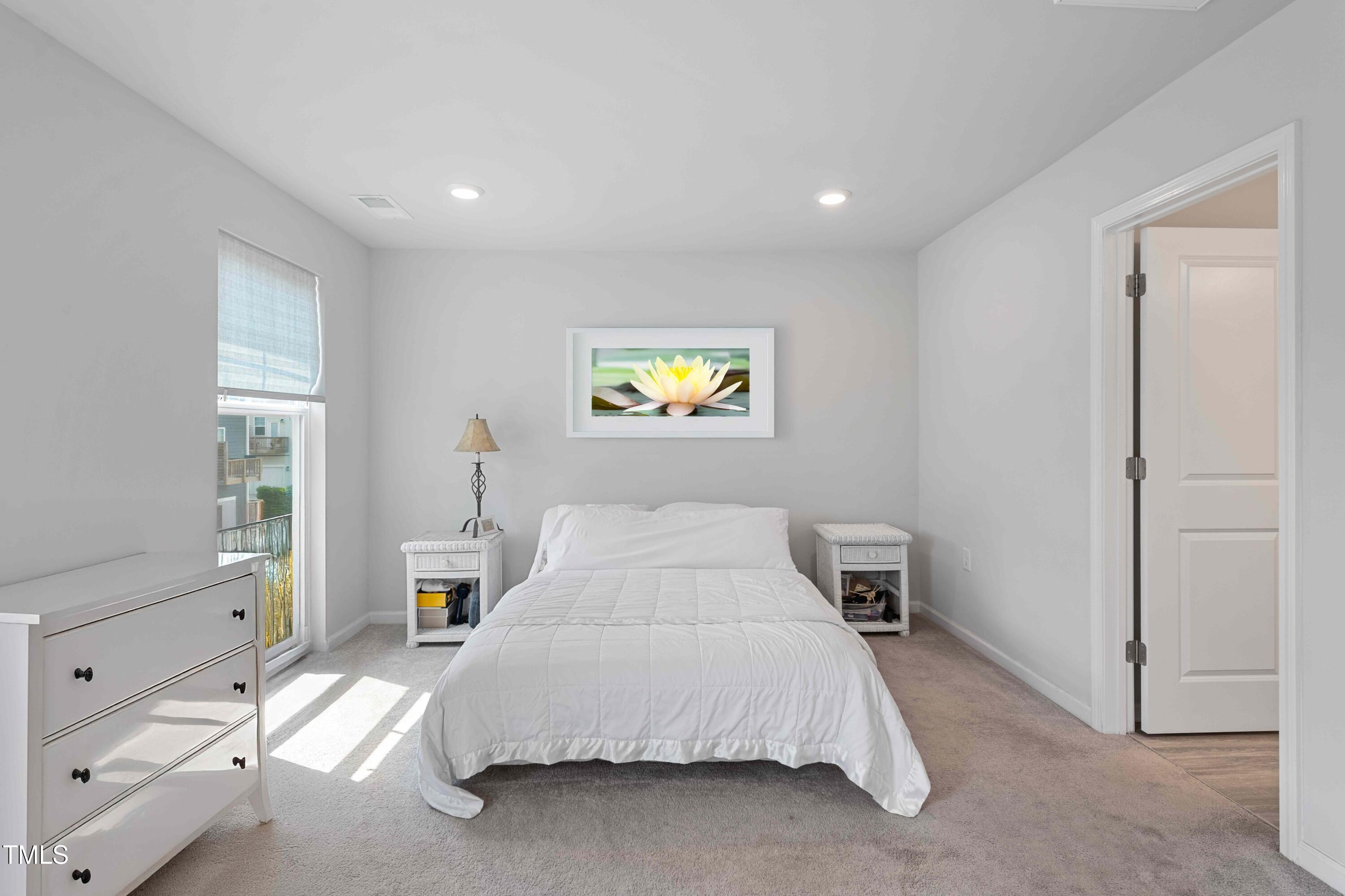 321 Devon Cliffs Drive Wake Forest, NC 27587 - Photo 11 of 26 a spacious bedroom with a bed and a window
