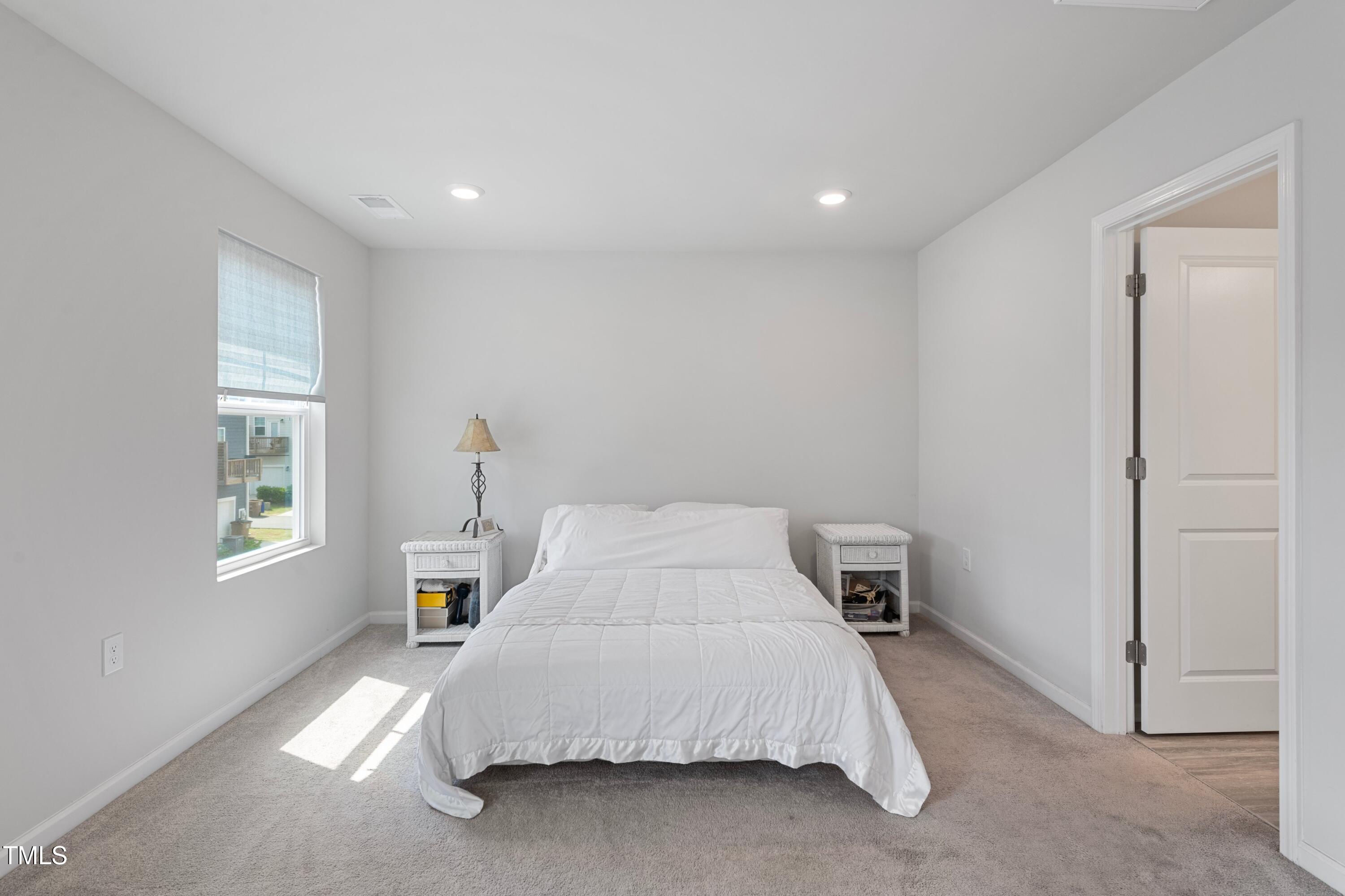 321 Devon Cliffs Drive Wake Forest, NC 27587 - Photo 12 of 26 a bedroom with a bed and a window