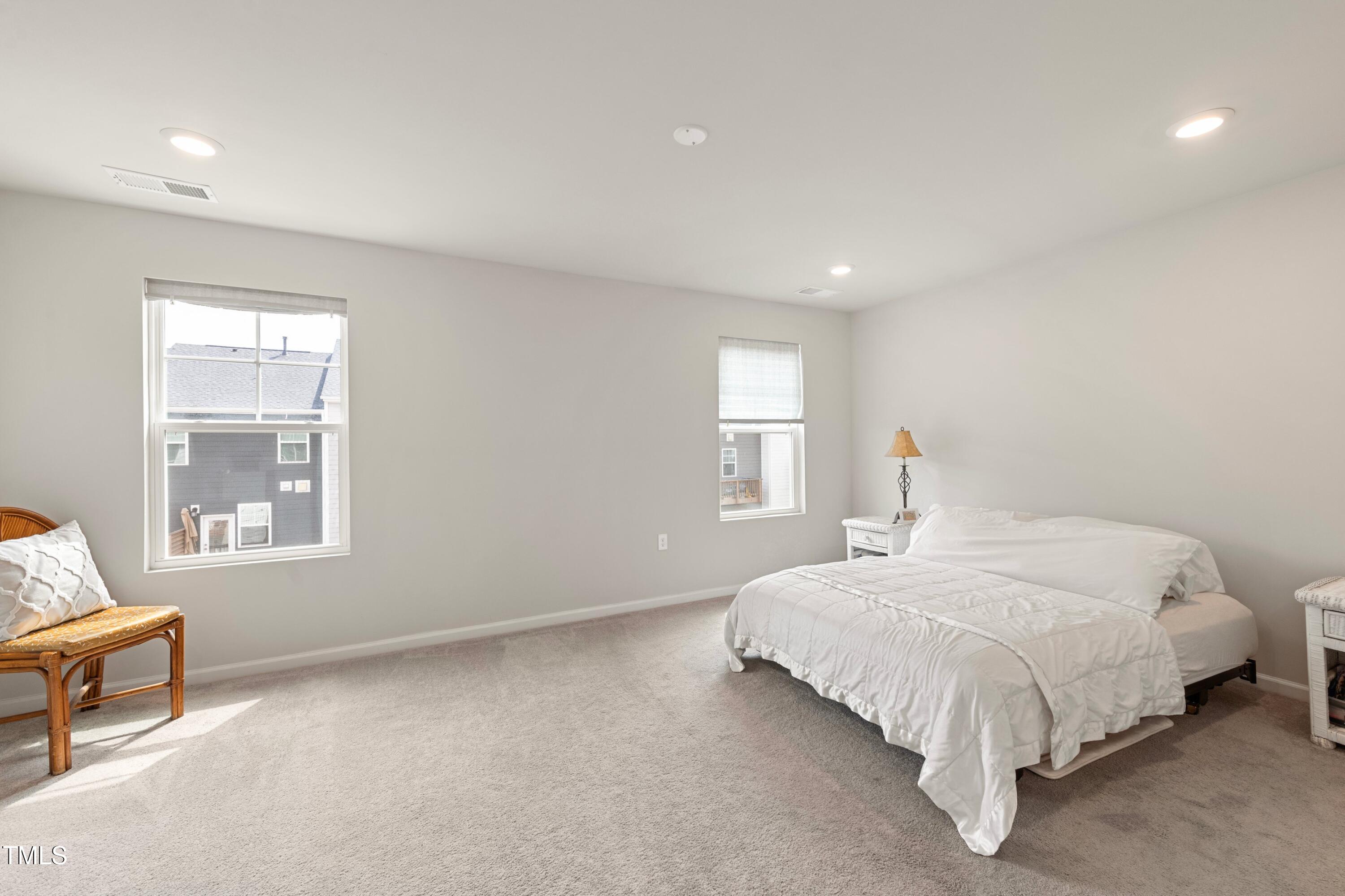 321 Devon Cliffs Drive Wake Forest, NC 27587 - Photo 13 of 26 a bedroom with a bed and a window