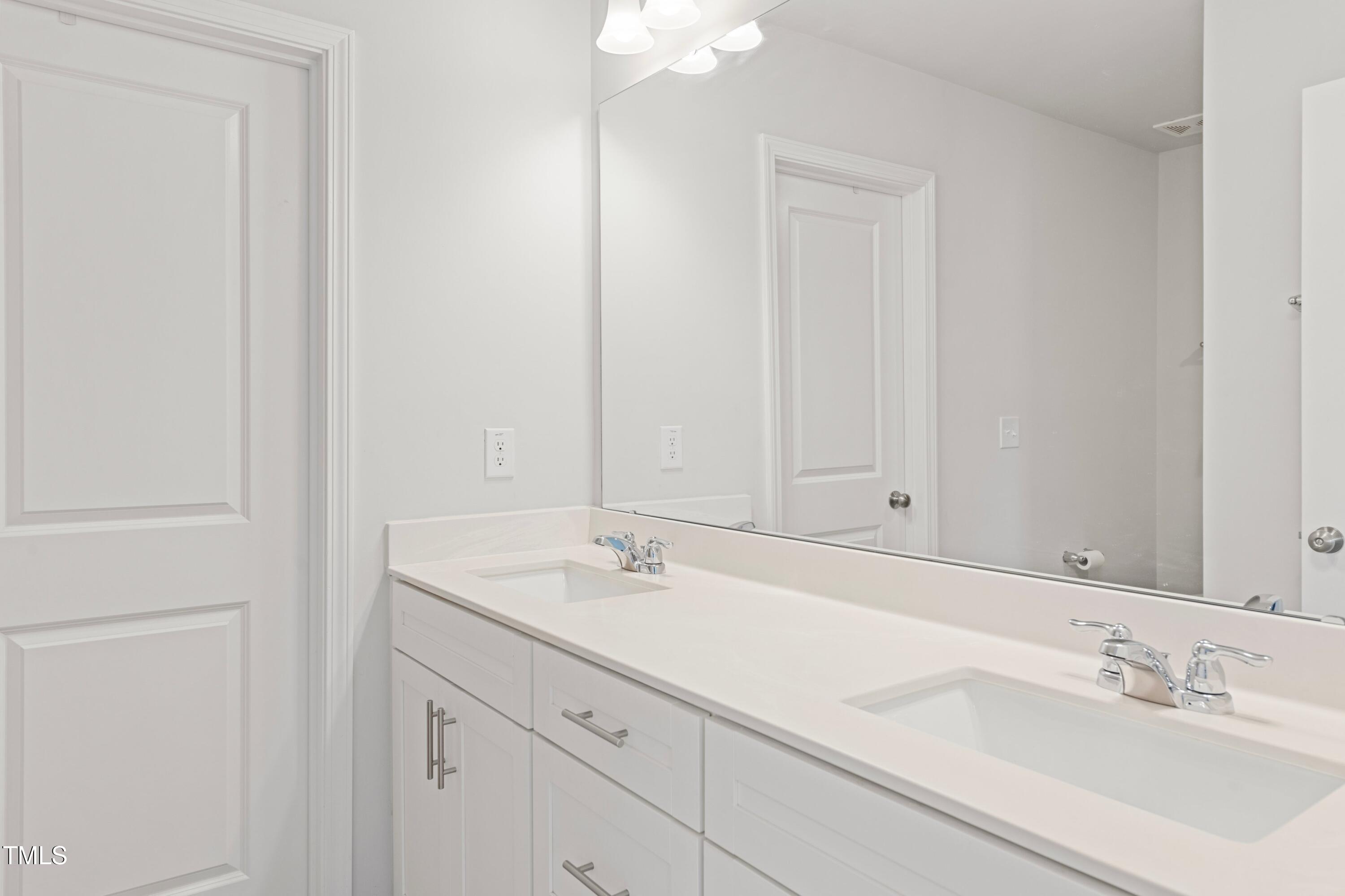 321 Devon Cliffs Drive Wake Forest, NC 27587 - Photo 14 of 26 a bathroom with a sink and a mirror