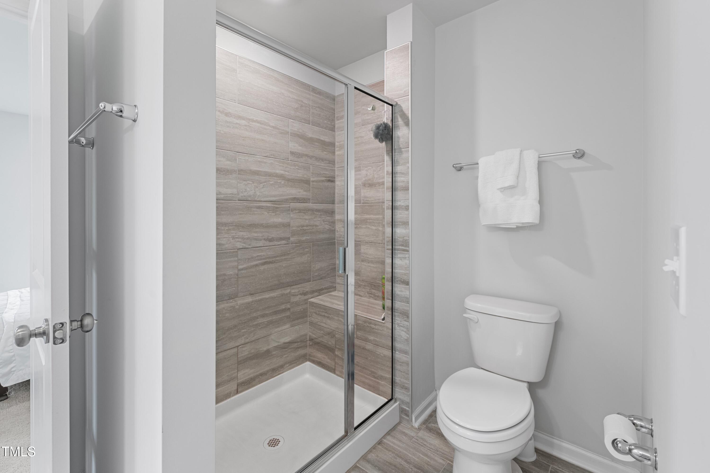 321 Devon Cliffs Drive Wake Forest, NC 27587 - Photo 15 of 26 a white toilet next to a bathroom sink