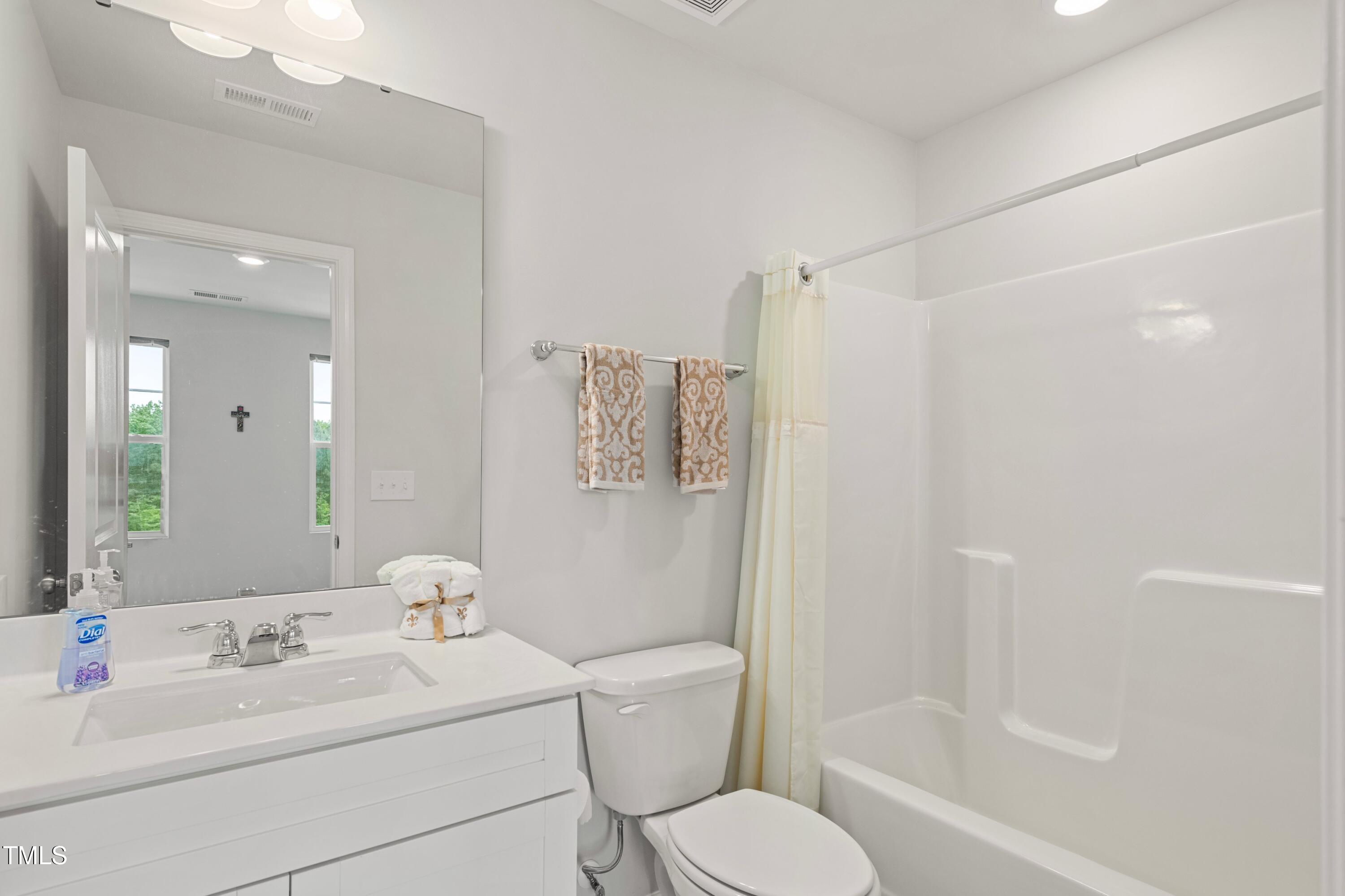 321 Devon Cliffs Drive Wake Forest, NC 27587 - Photo 18 of 26 a bathroom with a sink toilet tub and shower
