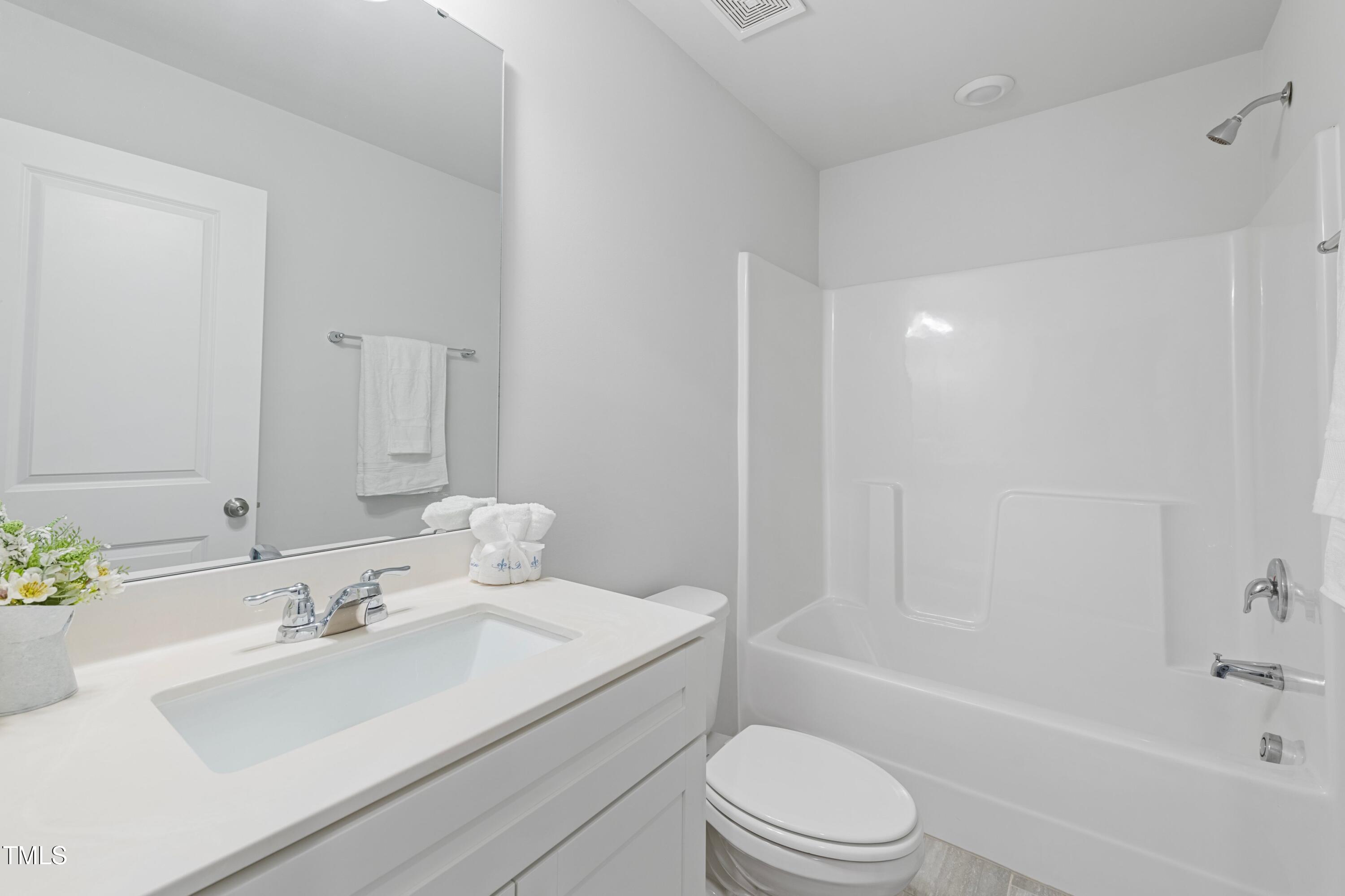 321 Devon Cliffs Drive Wake Forest, NC 27587 - Photo 19 of 26 a bathroom with a sink a toilet and shower