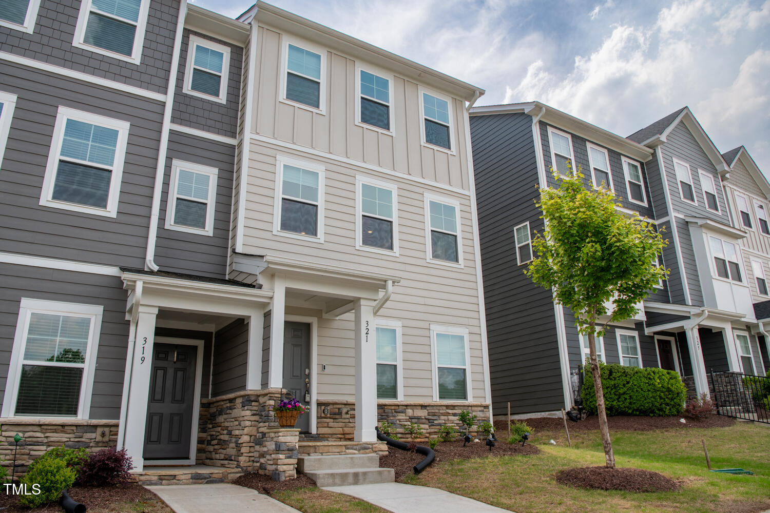 321 Devon Cliffs Drive Wake Forest, NC 27587 - Photo 21 of 26 view of a brick building next to a yard
