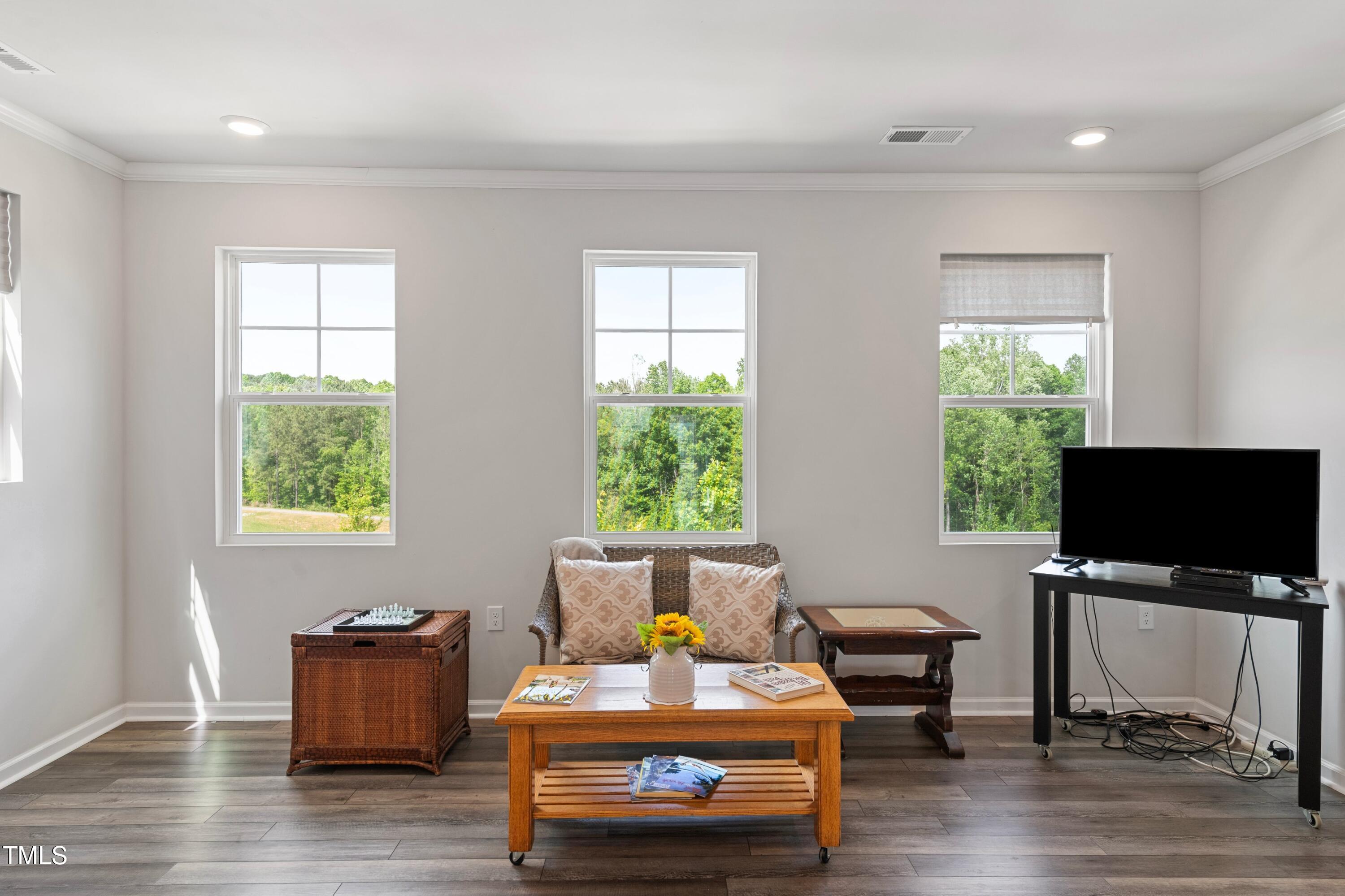 321 Devon Cliffs Drive Wake Forest, NC 27587 - Photo 4 of 26 a living room with furniture and a flat screen tv