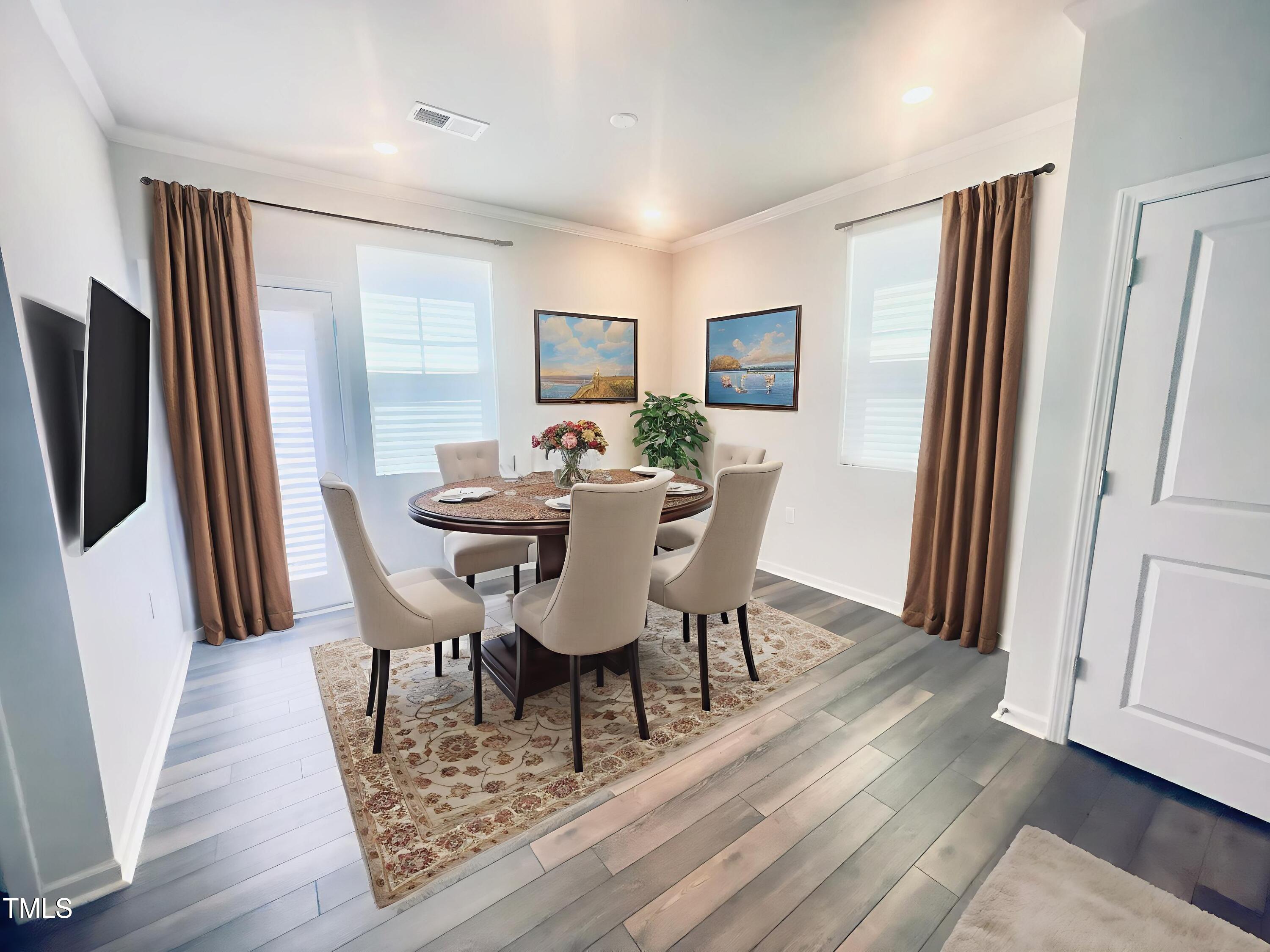 321 Devon Cliffs Drive Wake Forest, NC 27587 - Photo 5 of 26 a view of a dining room with furniture and a wooden floor