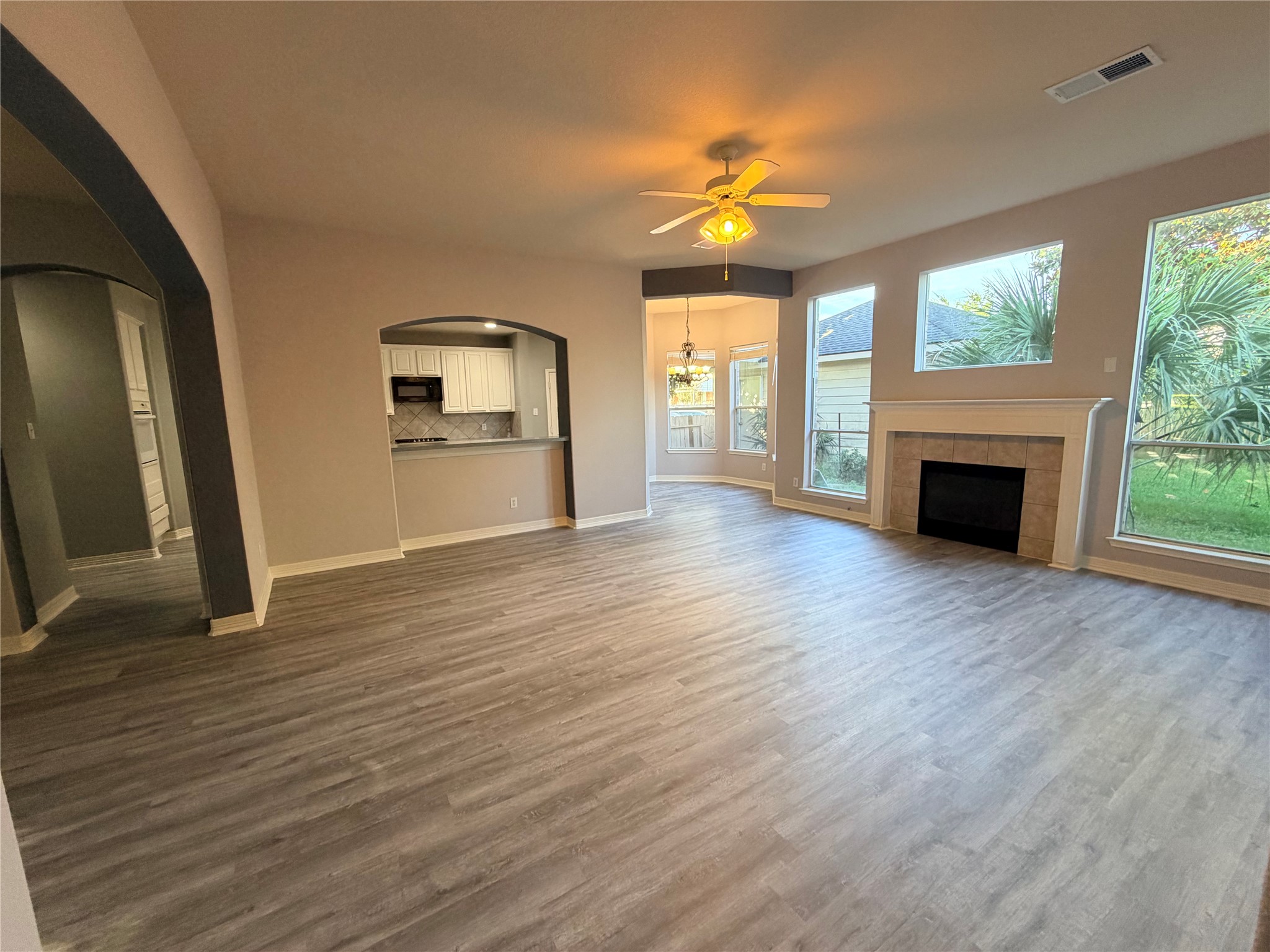 2303 Chelsea Ridge Court Katy, TX 77450 - Photo 9 of 12 a view of an empty room with wooden floor fireplace and a window