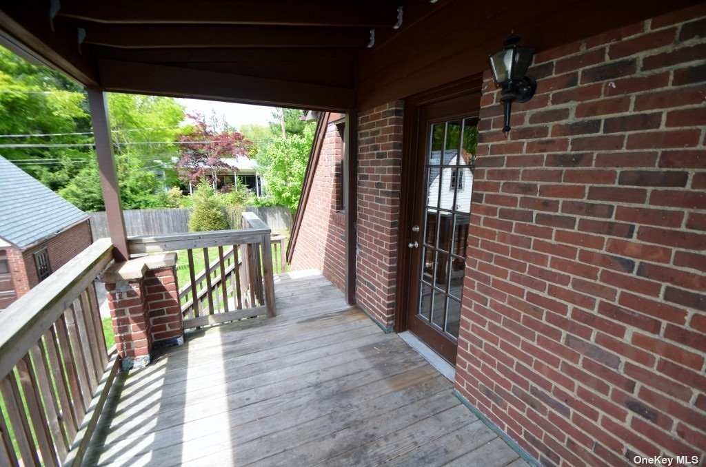 a view of a porch with wooden floor and outdoor space