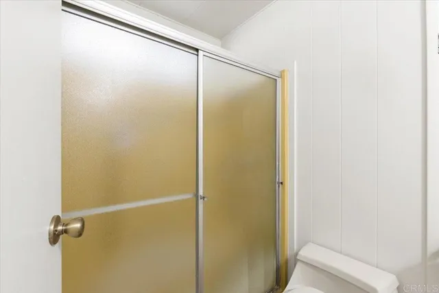 a bathroom with a glass shower door