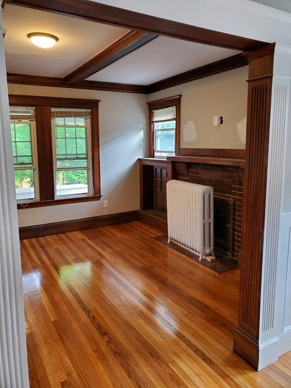 22 Allen Street, Unit 2 Arlington, MA 02474 - Photo 3 of 25 a living room with a balcony furniture and a fireplace