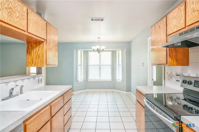 a spacious bathroom with a double vanity sink a mirror and a bathtub