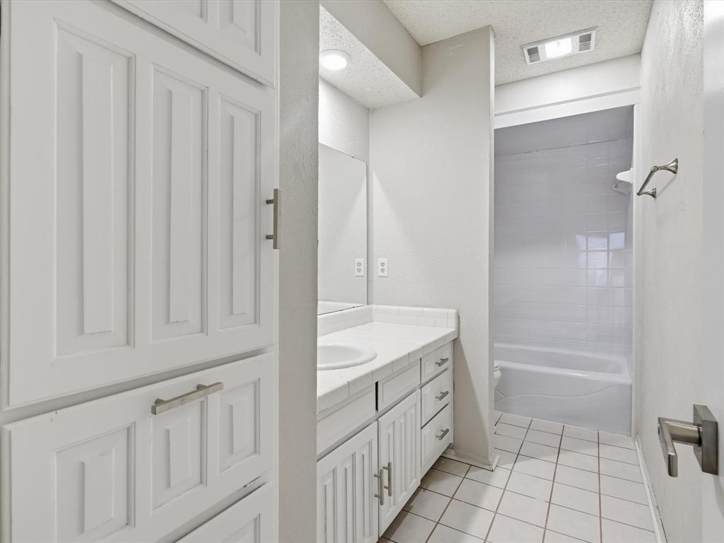 1811 Briarcrest Lane Arlington, TX 76012 - Photo 21 of 29 a bathroom with a granite countertop sink a toilet and a bathtub