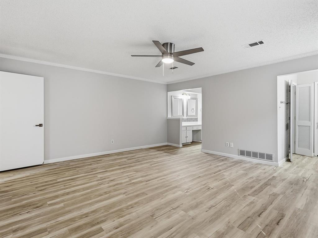 1811 Briarcrest Lane Arlington, TX 76012 - Photo 24 of 29 a view of an empty room with wooden floor and a window