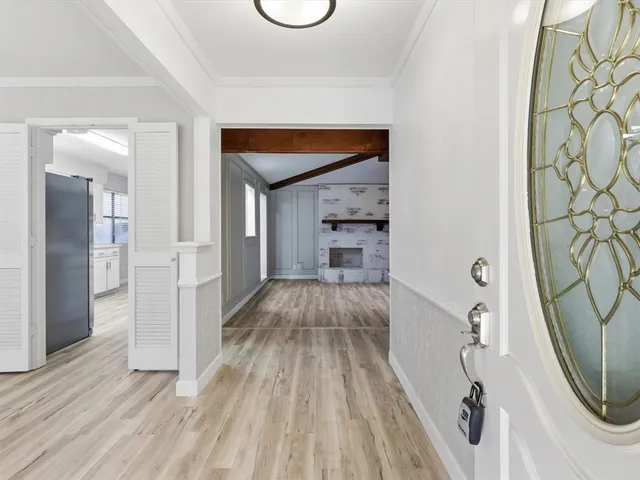 a view of a livingroom with a fireplace and wooden floor