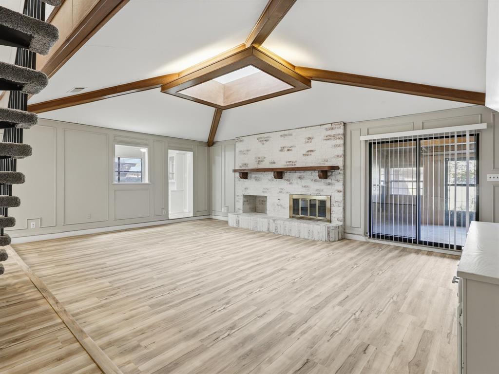 1811 Briarcrest Lane Arlington, TX 76012 - Photo 4 of 29 a view of a livingroom with a fireplace and wooden floor