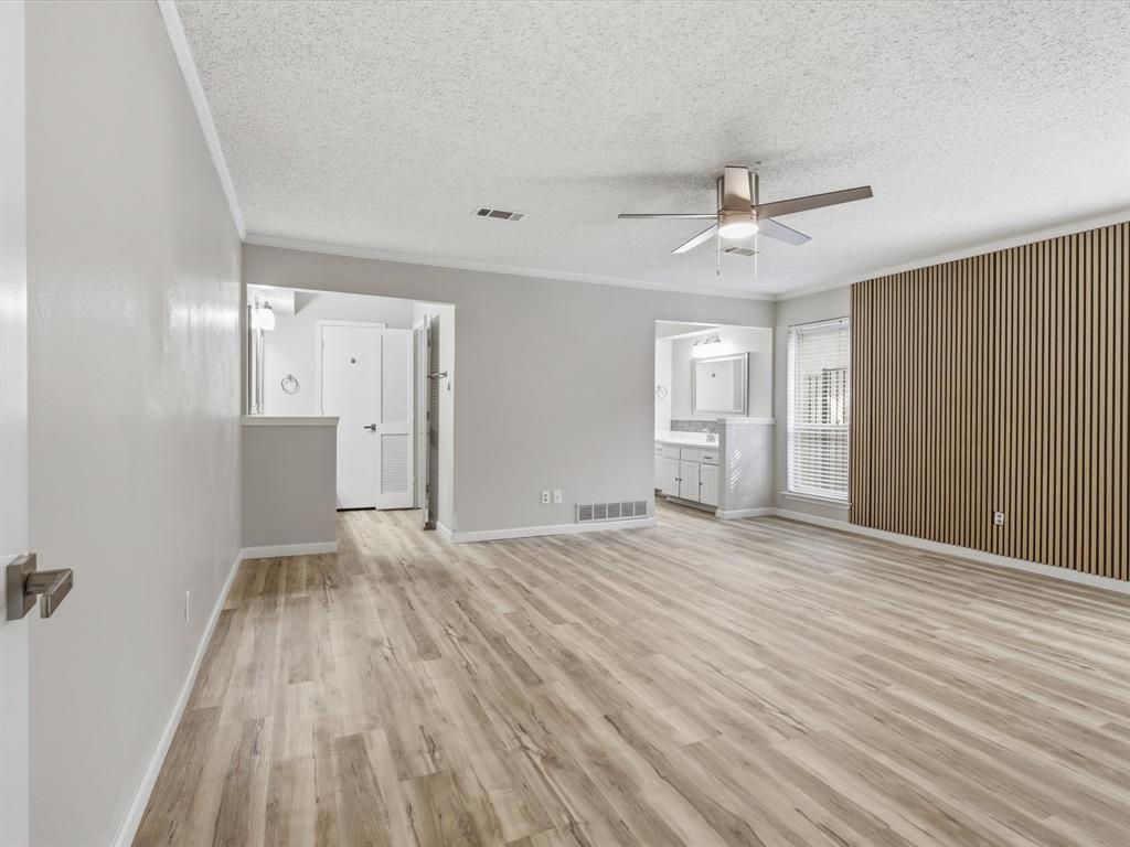 1811 Briarcrest Lane Arlington, TX 76012 - Photo 8 of 29 a view of empty room with wooden floor and fan