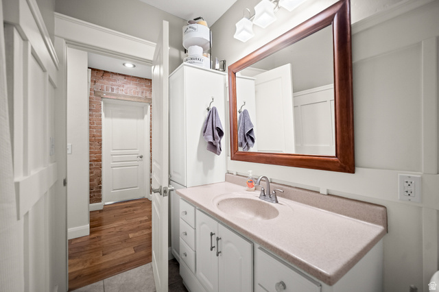 236 West 300 South Hurricane, UT 84737 - Photo 26 of 76 Vanity with an integrated sink and light-toned countertop, set against wainscoting