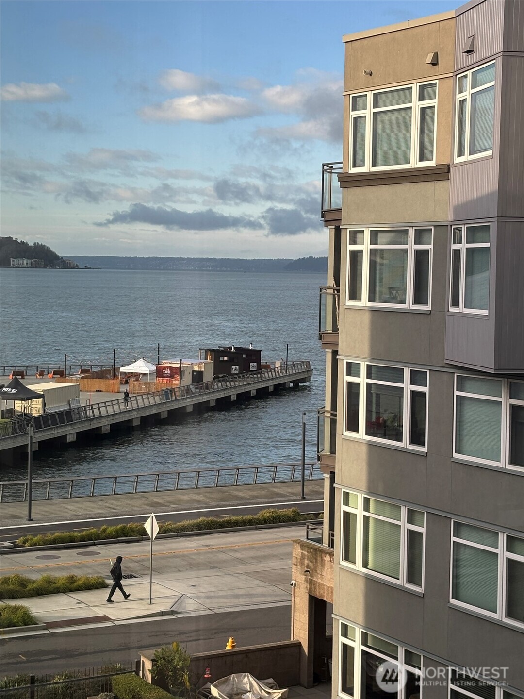 1900 Alaskan Way, Unit 402 Seattle, WA 98101 - Photo 1 of 32 a view of a lake with a building and trees in the background