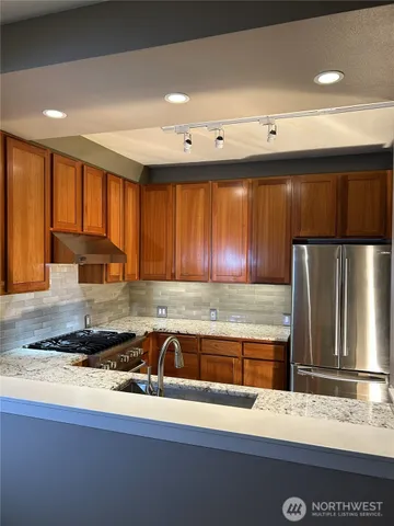 a kitchen with a sink and a stove top oven