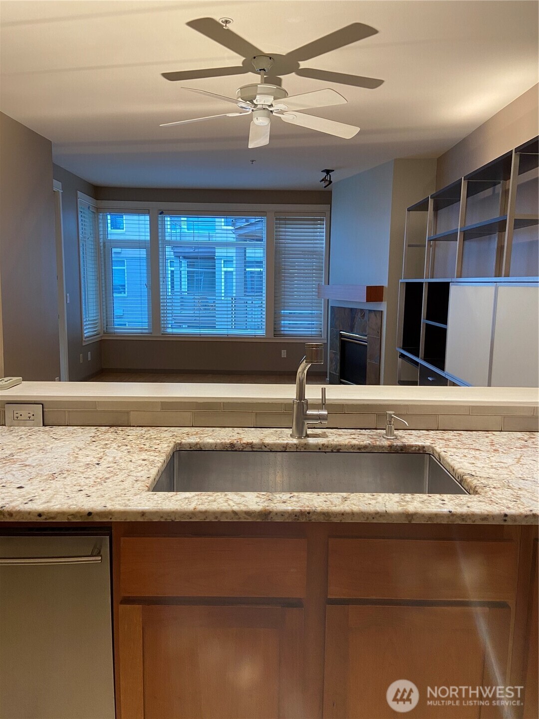 1900 Alaskan Way, Unit 402 Seattle, WA 98101 - Photo 13 of 32 a view of kitchen with granite countertop a sink and a counter top space