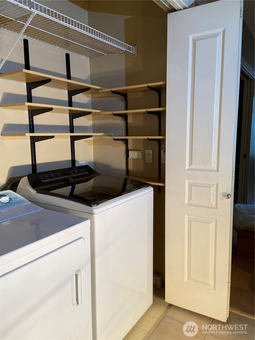 1900 Alaskan Way, Unit 402 Seattle, WA 98101 - Photo 14 of 32 a view of storage and utility room with washer and dryer