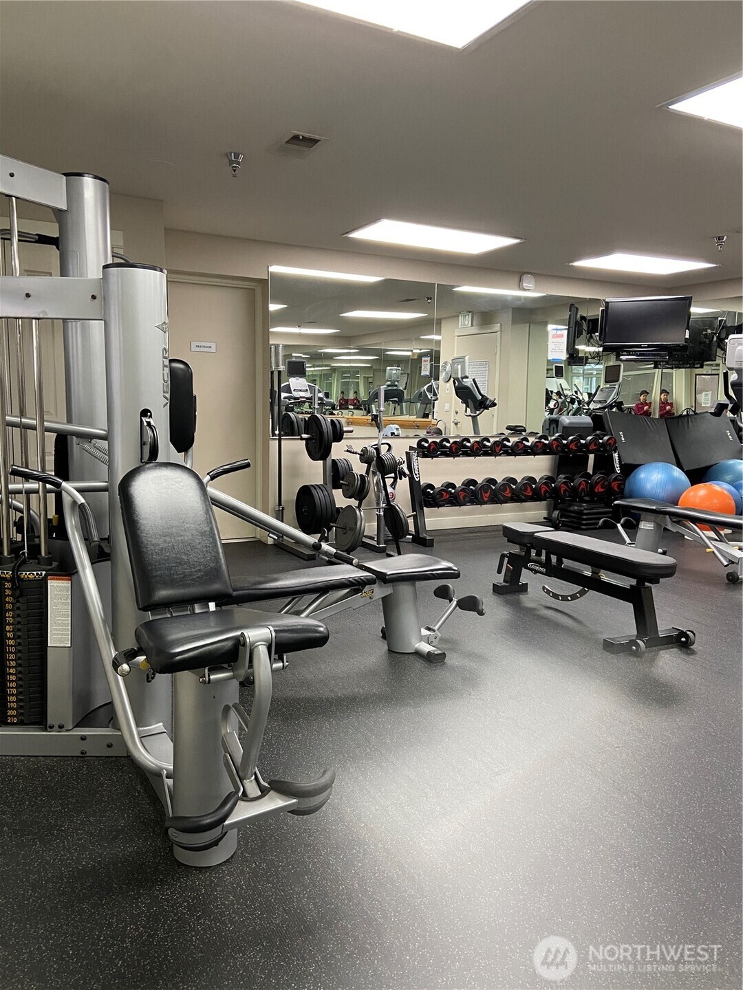 1900 Alaskan Way, Unit 402 Seattle, WA 98101 - Photo 25 of 32 a room with gym equipment and a large window