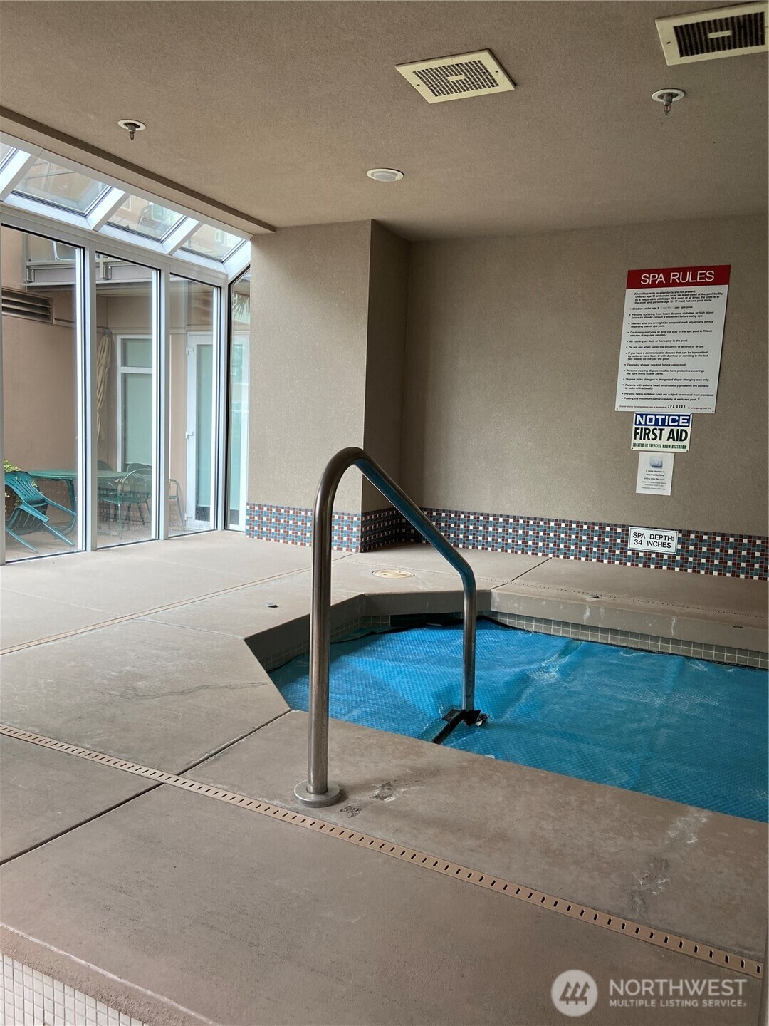 1900 Alaskan Way, Unit 402 Seattle, WA 98101 - Photo 27 of 32 a view of a hallway with wooden floor and a potted plant