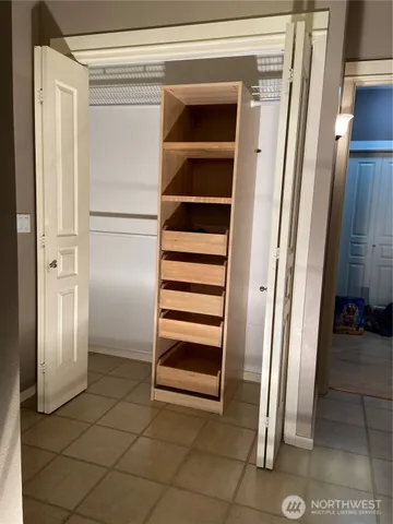 a view of an empty room with empty shelves