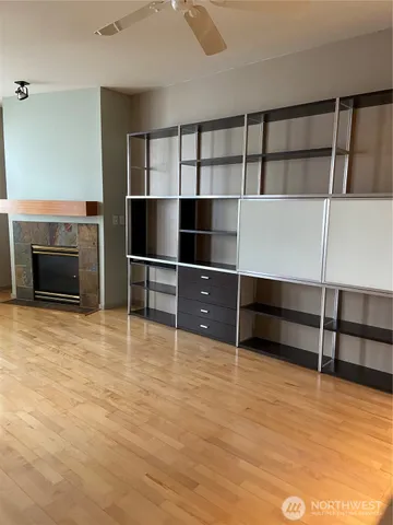 a view of an empty room with cabinet and a window