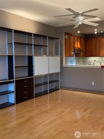 a view of an empty room with a fireplace and cabinets