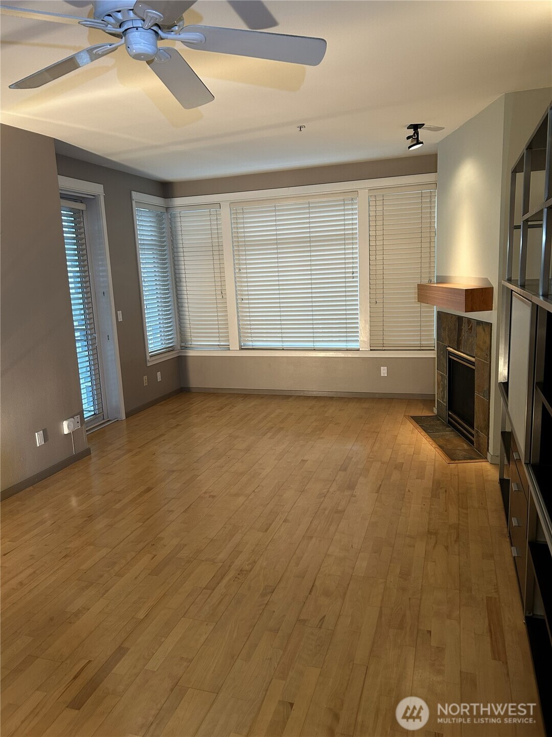 1900 Alaskan Way, Unit 402 Seattle, WA 98101 - Photo 8 of 32 a view of livingroom with hardwood floor and a ceiling fan